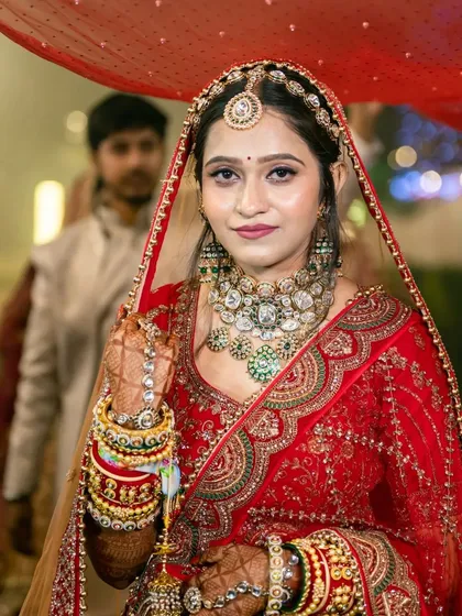 The bride's grand entrance, a classic shot capturing her beauty and the richness of her traditional red bridal attire.