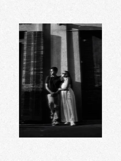 A dramatic black and white shot using strong shadows and light. This artistic pre-wedding portrait in Mumbai highlights the couple's connection in a moody, cinematic style.