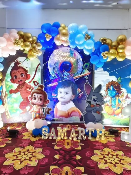 A divine Little Krishna theme for a first birthday. This setup includes cute cartoon Krishna cutouts, a blue and gold balloon arch, and a personalized backdrop, perfect for a blessed celebration.
