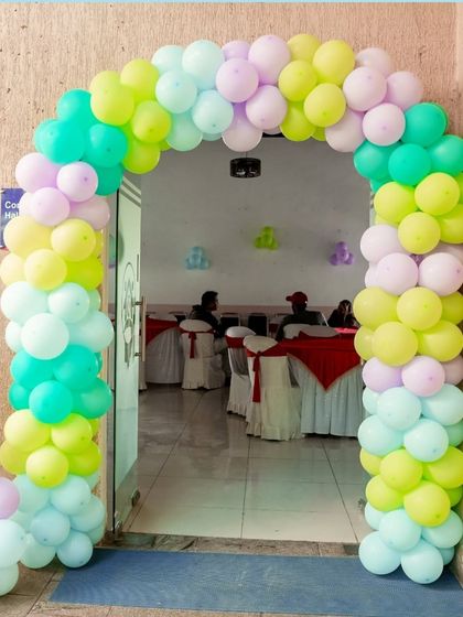 A vibrant 'Encanto' themed birthday party, with colorful floral decor, character cutouts, and a custom backdrop of the magical casita, bringing the magic of Colombia to your event.