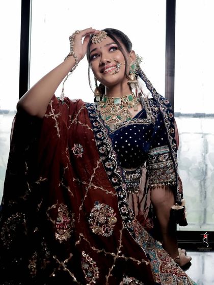 This photo captures the bride's joyful personality. Her makeup is kept soft and subtle to let her happiness and the stunning details of her outfit shine.