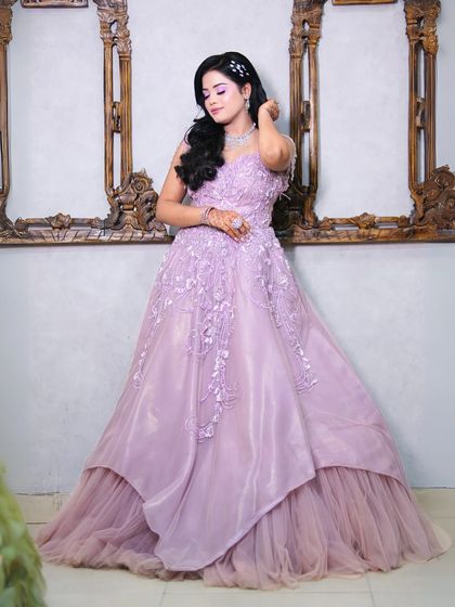 A full shot of our beautiful lilac ball gown. The layered tulle skirt and floral applique on the bodice create a true fairytale look.