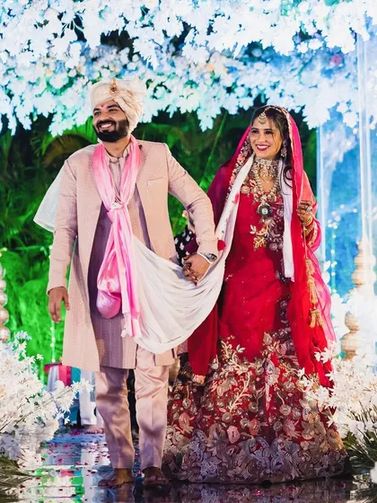 Walking hand-in-hand. This photo shows the beautiful embroidery on my wedding lehenga and the happiness of the moment.