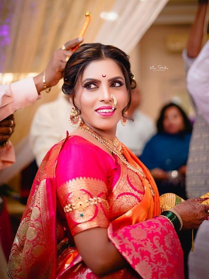A candid moment during the ceremony as a final touch is made to the bride's hair. Her bright smile shows she is enjoying every moment of her special day.