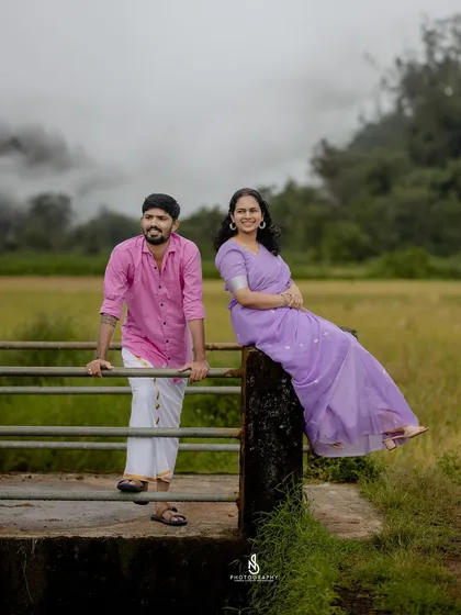 A relaxed, confident pose on the bridge, showcasing the couple in their beautiful natural surroundings.