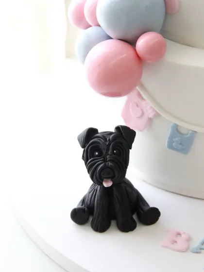 A close-up of one of the three adorable schnauzer dog toppers, specially requested by the client to include their beloved pets.