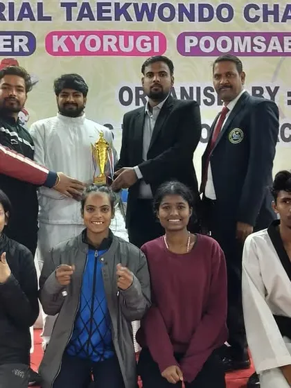 Receiving the team trophy at the Memorial Taekwondo Championship. Our collective performance speaks volumes.