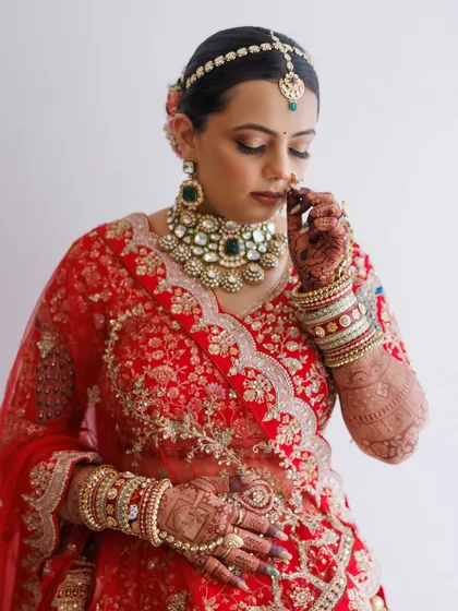 A quiet moment of reflection. This shot captures the intricate details of her jewelry and the soft, blended eyeshadow, creating a look of serene beauty.