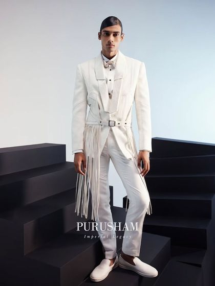 This modern white suit, with its unique fringed belt and structured shoulders, is a centerpiece of my Summer Edit. It is designed for the man who wants to make a bold statement.