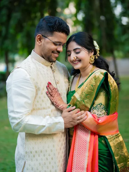 An intimate portrait of Jagruti and Shubham in a lush garden setting. The bride's hand on the groom's chest creates a feeling of love and connection.
