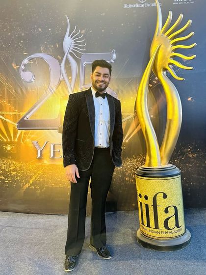 Another photo from the IIFA Awards, posing with the iconic trophy. My custom black tuxedo was the perfect choice for a night celebrating cinema and style.