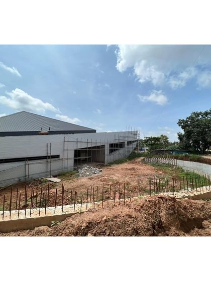 The rear of the sports center during construction, showing where the building begins to merge with the landscape.