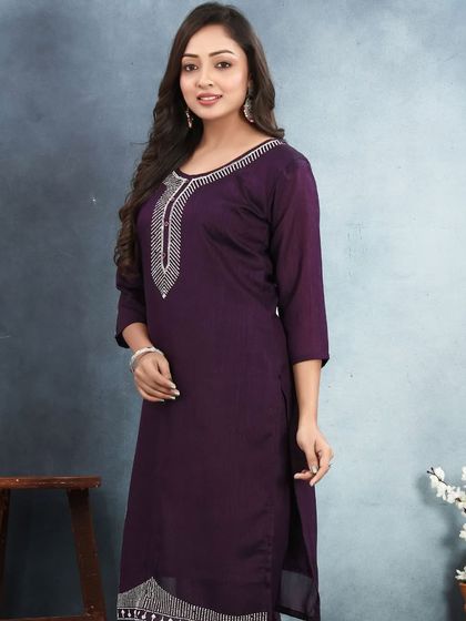 This purple vichitra silk kurta has a simple, elegant design with stone work on the neckline. It's a great choice for a comfortable yet put-together look.
