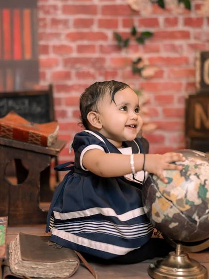 A gallery of our popular school and library theme. These images show the versatility of the brick wall backdrop, mini school desk, globe, and book props for creating a variety of scholarly and classic portraits.