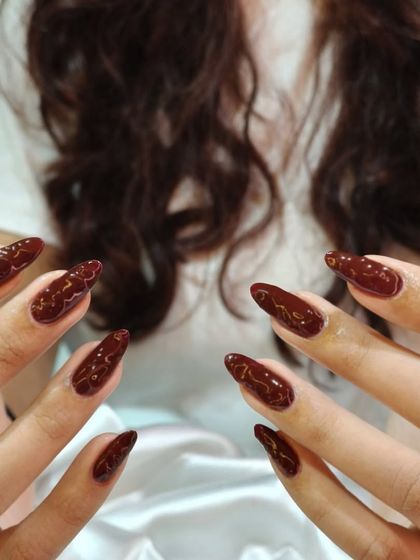 Another view of our popular maroon swirl design. The glossy finish catches the light, highlighting the delicate patterns within the rich, dark color.