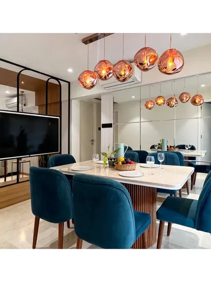 This view shows the dining area in relation to the living room's TV partition, highlighting the open yet defined layout of the home.