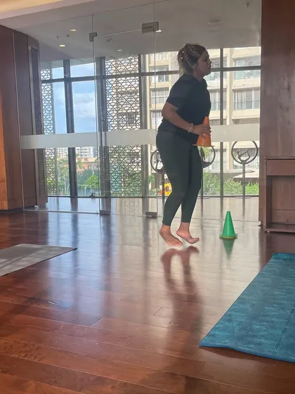 A client doing plyometric jumps during a functional training session. Explosive movements like this are great for building power and improving cardiovascular health.