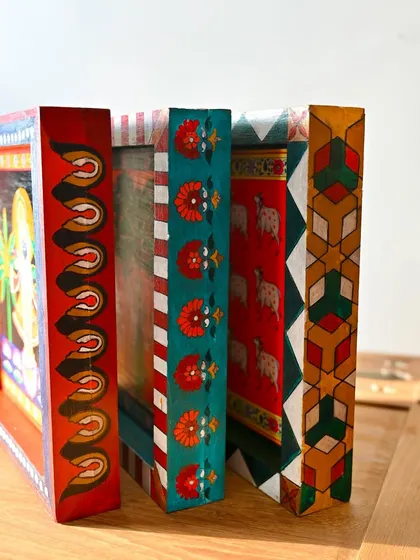 A side view of the three blocks, highlighting the different hand-painted patterns on each frame. Every surface is a canvas.