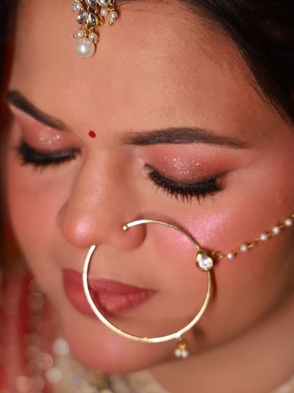 A close-up of the bride's soft glam eye makeup. The shimmer is delicate, and the lashes are lightweight, creating a romantic and dreamy effect.