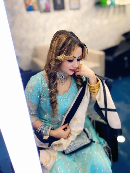 The complete look, featuring a soft curly hairstyle and elegant makeup. This is a great example of a coordinated hair and makeup service for a wedding guest or bridesmaid.