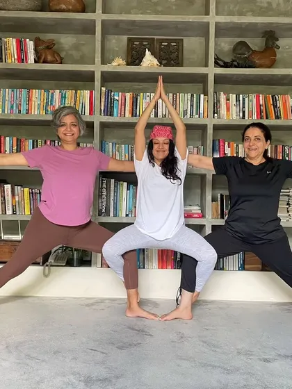 A playful moment of connection. Three of us creating a fun shape together, blending our energies in a partner yoga pose. This shows the lighthearted spirit and friendship that blossoms during our yoga vacations.