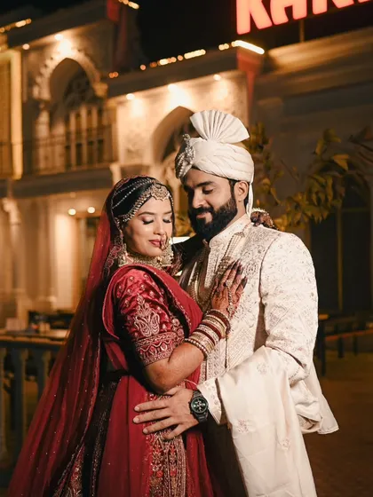 A classic couple portrait taken at night. The grand architecture and soft lighting add a touch of elegance and romance to the scene.