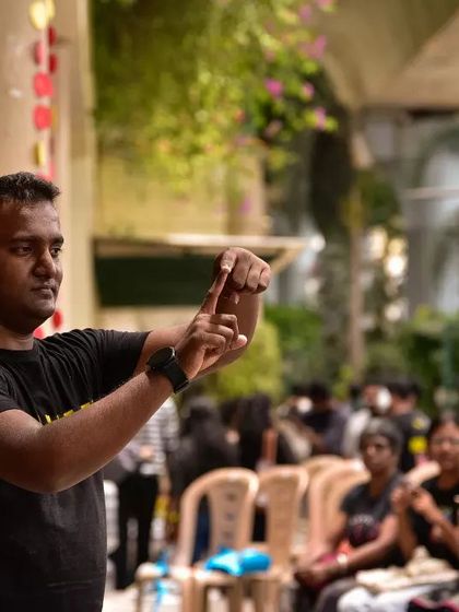 A Deaf volunteer leads a session at Sign Fest, teaching the basics of Indian Sign Language. Our workshops are led by community members, ensuring an authentic and empowering experience.