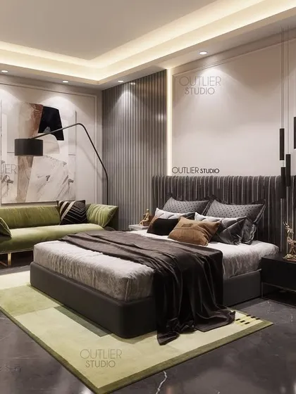 One of our favorite bedrooms, featuring a dark floor, a green sofa, and a textured headboard. The mix of materials and colors creates a space that is both sophisticated and comfortable.