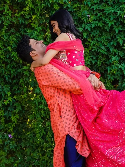 A moment of pure joy and abandon. The groom lifts his bride, and her laughter fills the air. It's these unscripted, happy moments that I love to capture.