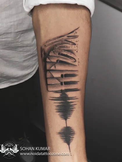 A custom design that blends piano keys with a soundwave. This is a perfect tattoo for a musician or music lover, creatively visualizing their passion.