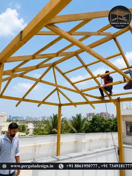 The client inspects the work in progress as our team continues to build the large rooftop pergola structure.