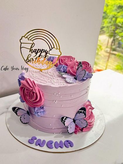 Blooming with sweetness and fluttering with joy. A pink and purple butterfly and flower cake.