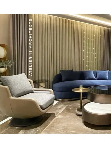 Designed for a family in Shanti Niketan, this lounge combines a bold curved blue velvet sofa with a sleek nesting table and a beige swivel armchair. The composition creates a perfect blend of warmth and contemporary sophistication.