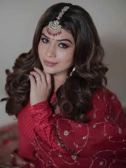 A softer, more engaging pose from the same series. Her gentle smile and hand gesture add a touch of warmth and personality to this elegant fashion portrait.