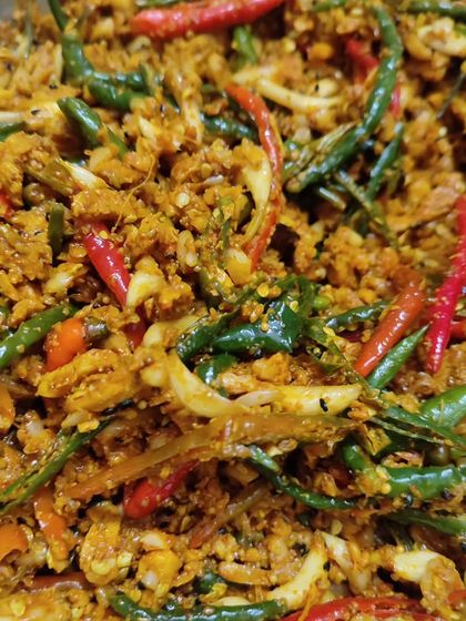 A close-up of the texture of my ginger, garlic, and chilli pickle. You can see the finely chopped ingredients, all coated in a delicious blend of traditional Indian spices.