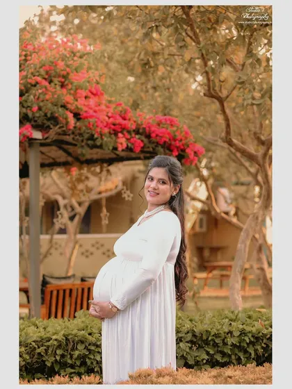 The vibrant colors of nature, like these beautiful bougainvillea flowers, can add a wonderful pop to your outdoor maternity photos while keeping the feel soft and romantic.