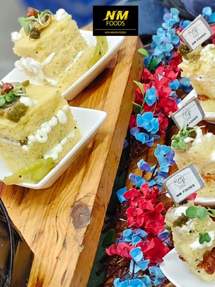 Our savory dhokla sandwiches are a light and fluffy appetizer. Layered with chutney and cream, they are a modern twist on a traditional Gujarati snack.