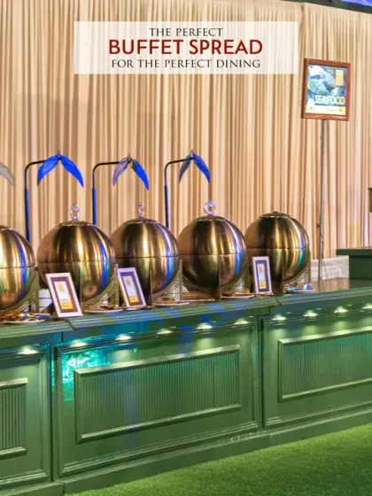 A perfect buffet spread for perfect dining. This image highlights our classic setup with gleaming golden chafing dishes arranged on a beautifully lit counter, ready to serve a variety of delicious hot dishes to your guests.