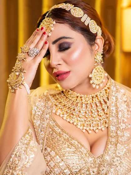 We had the pleasure of shooting with celebrity Arshi Khan for a glamorous portfolio session. This image captures a dramatic look with dark, smoky eyes, bold lips, and heavy gold jewellery, showcasing our experience in creating high-impact looks for well-known personalities.