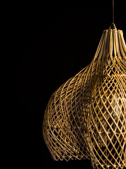 This image captures the elegant, twisting form of another of my sculptural pendants. The complex curves and open weave are designed to be a conversation starter.