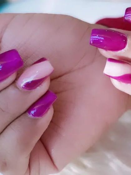 A bold design with glossy magenta and abstract white swirls on square-shaped nails.