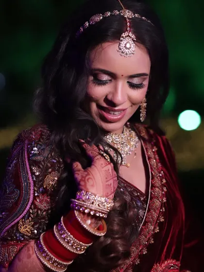 Palak's reception look was all about subtle elegance. Her multi-colored lehenga was paired with a soft makeup look and beautiful open waves.