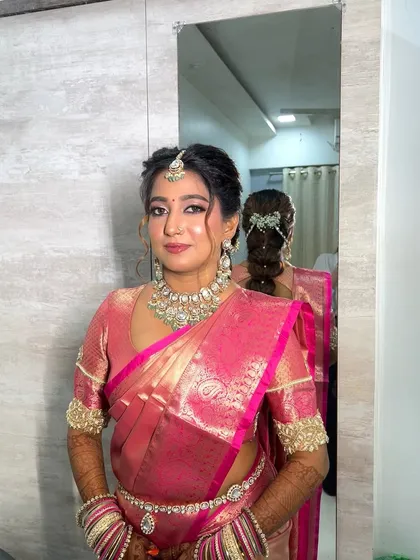A mirror selfie capturing the full effect of this stunning saree look. The makeup, hair, and outfit all come together to create a picture of bridal perfection.