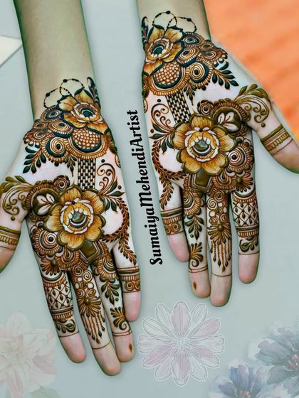 I love how these bold, yellow-tinted flowers look on the palms. This is a great example of a floral design that is both striking and elegant.