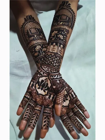 This pose shows how the different elements of a complex design come together. You can see the elephant motif on the arm, the central lotus on the palm, and the detailed finger work all at once.