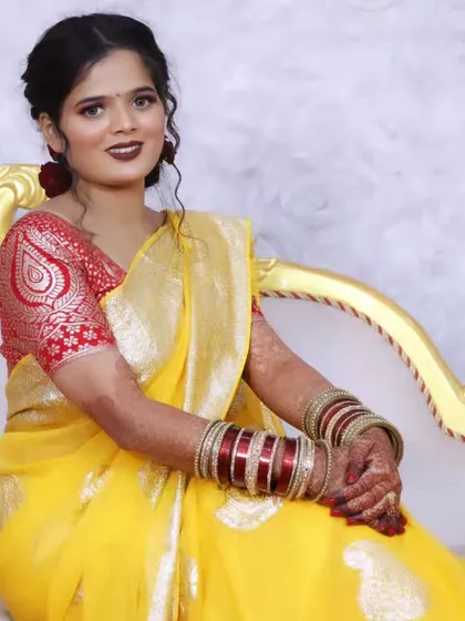 Another seated portrait, highlighting the rich fabric of the saree and the intricate blouse design.
