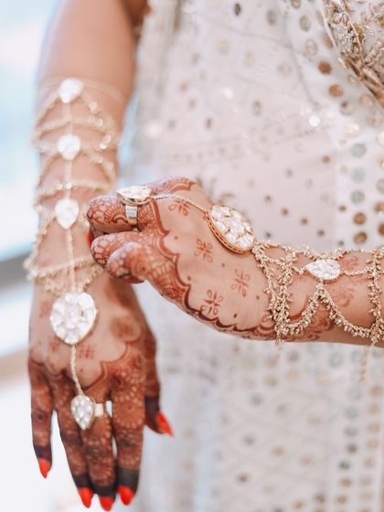 A close-up of the custom hand harness I designed for my baby shower, featuring beautiful uncut stones and delicate chains.