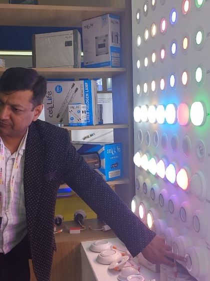 An attendee gets a close look at a colorful LED panel, demonstrating the interactive nature of the product displays.