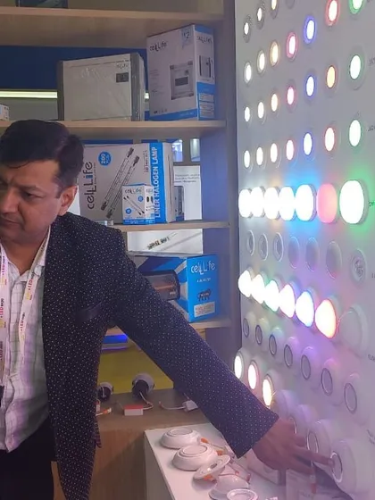 An attendee gets a close look at a colorful LED panel, demonstrating the interactive nature of the product displays.