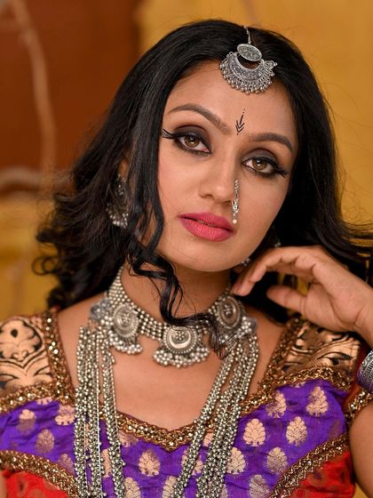 A close-up that highlights the intricate silver jewelry and the dramatic eye makeup of the Rajasthani look. The details are sharp and clear, perfect for a portfolio.